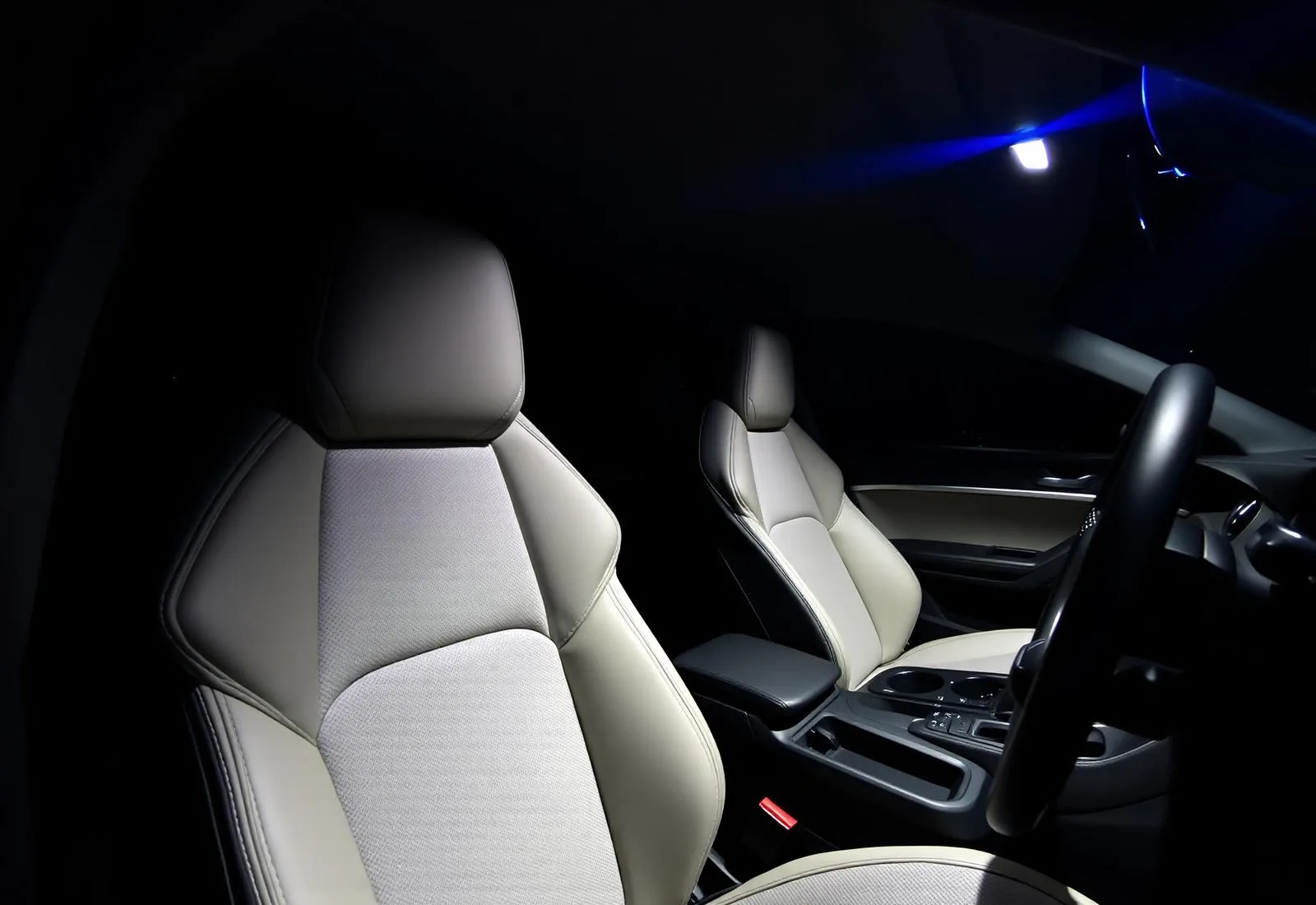 Clean vehicle interior with front seats, dashboard and center console after interior detailing