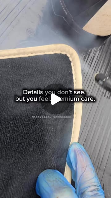 Grandett detailer extracting dirt from vehicle carpet during premium interior detailing