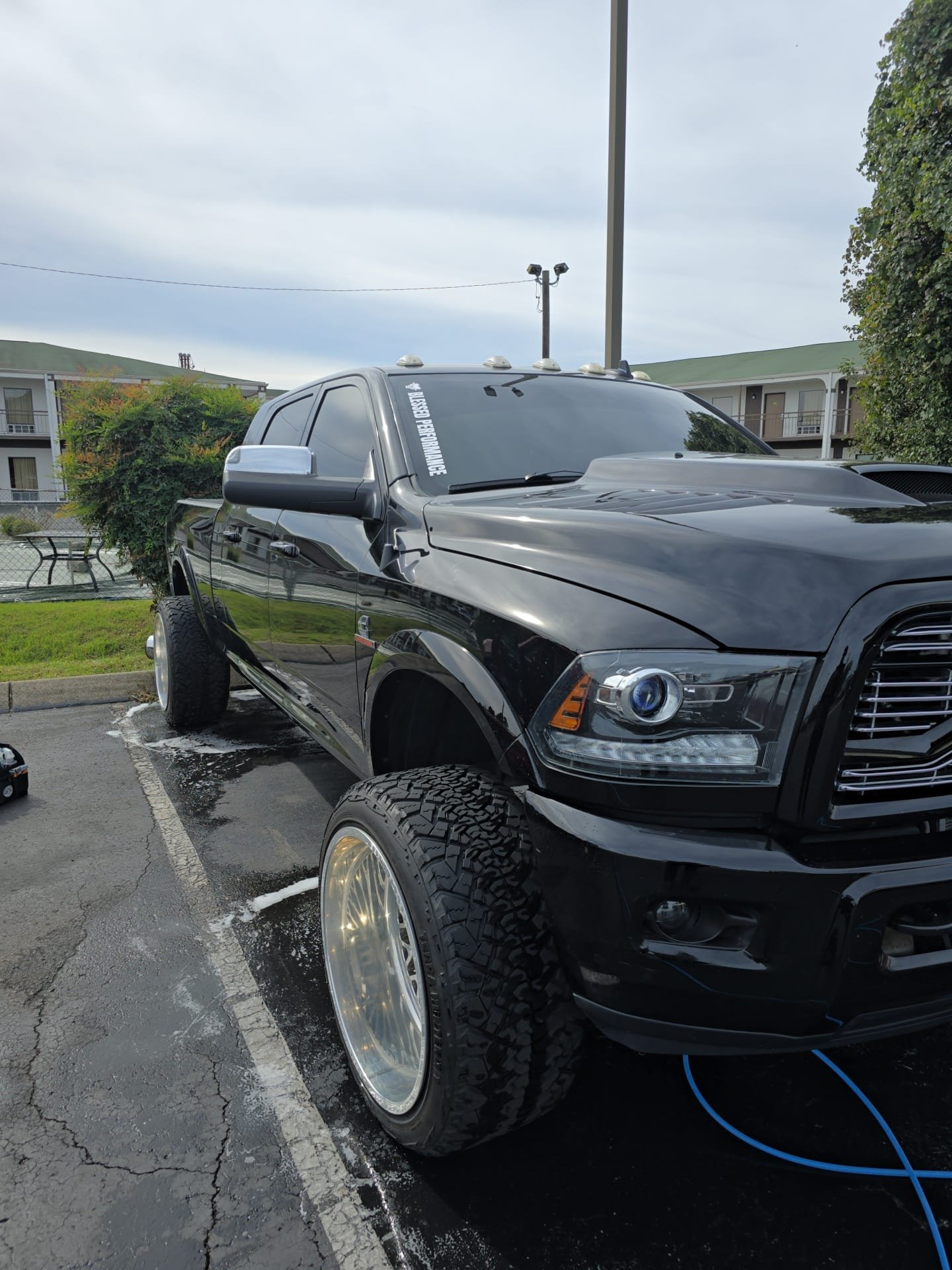 Professional auto detailing service on black pickup truck exterior